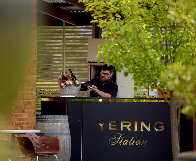 Staff member preparing drinks at the Yering Station outdoor garden bar