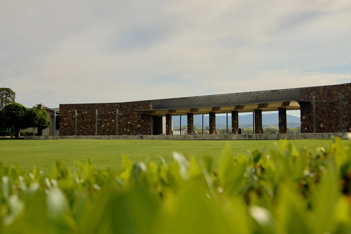 Yering Station's stone-walled cellar door building viewed across the lawn